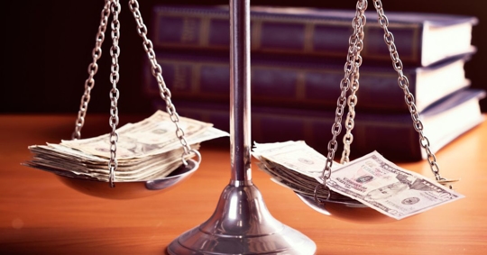 Scales of justice with stacks of money. If you have questions about the probate process, contact Jerimy Kirschner & Associates.