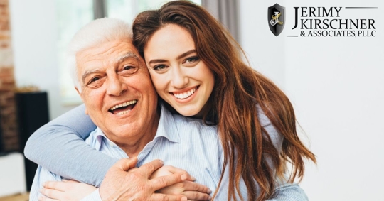 Adult woman hugging her older father or grandfather