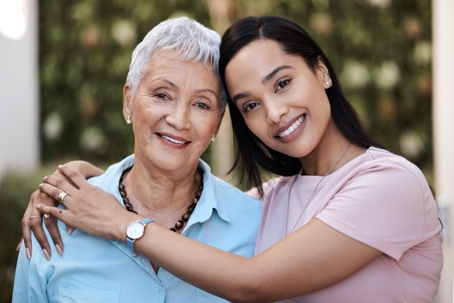 Adult woman hugging her older mother